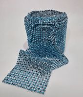 Стразы-обманки на полотне. Ширина 12 см, длина 9 метров. Цвет голубой. Вес 700 гр.